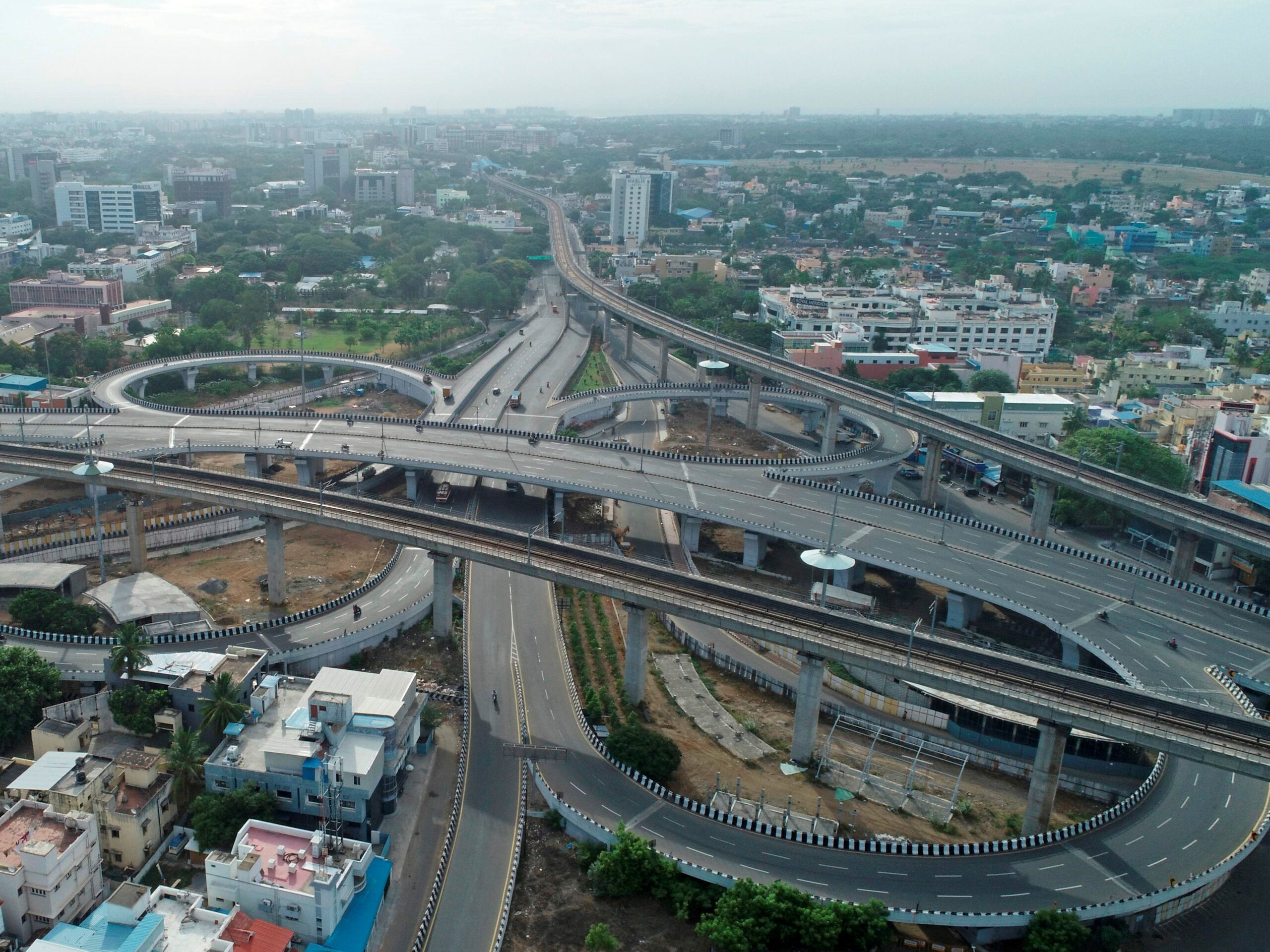 Motorists are seen on a deserted Guindy flyover after a lockdown was reimposed as a preventive measure against the spread of the COVID-19 coronavirus, in Chennai on June 19, 2020. - The epidemic has badly hit India's densely populated major cities and Chennai in the south has ordered a new lockdown from June 19 because of a surge in cases. (Photo by Arun SANKAR / AFP)